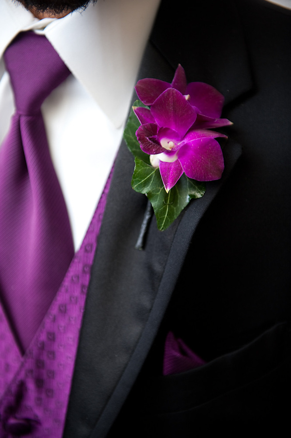 groomsman wearing black suit with purple vest and tie and purple and green floral boutonniere - photo by Houston based wedding photographer Adam Nyholt